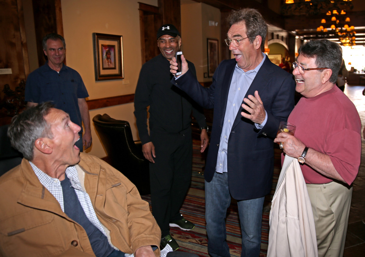 Huey Lewis surprises his fellow Musketeer as Roger Craig and Eddie DeBartolo look on.